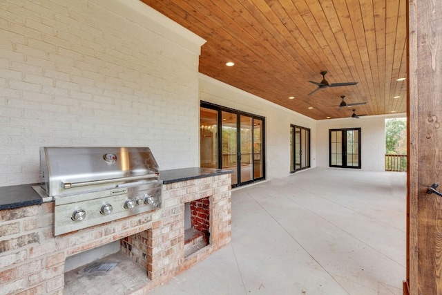 view of patio / terrace with grilling area, an outdoor kitchen, and a ceiling fan