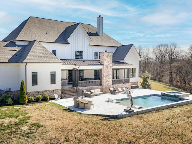 rear view of house featuring a shingled roof, an outdoor hangout area, a chimney, a yard, and a patio