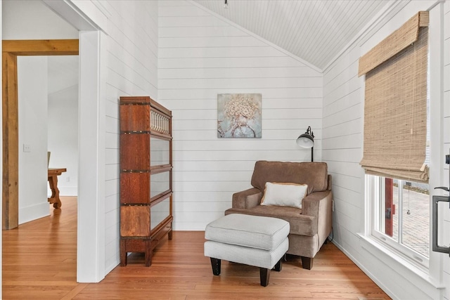 living area featuring lofted ceiling and light wood finished floors