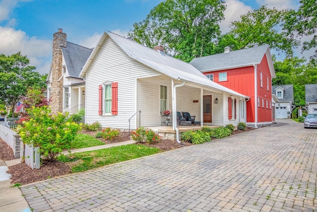 view of front of house with covered porch and a chimney