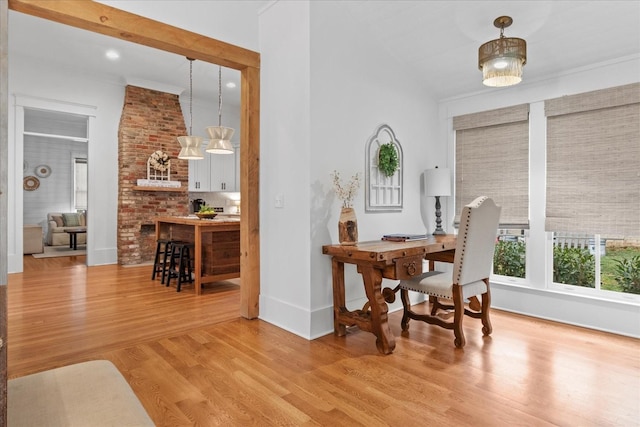 dining space with light wood-style flooring and baseboards