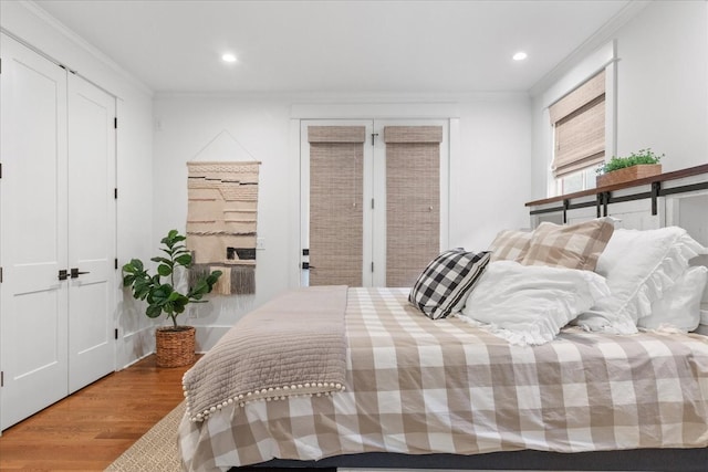 bedroom featuring ornamental molding, recessed lighting, and wood finished floors