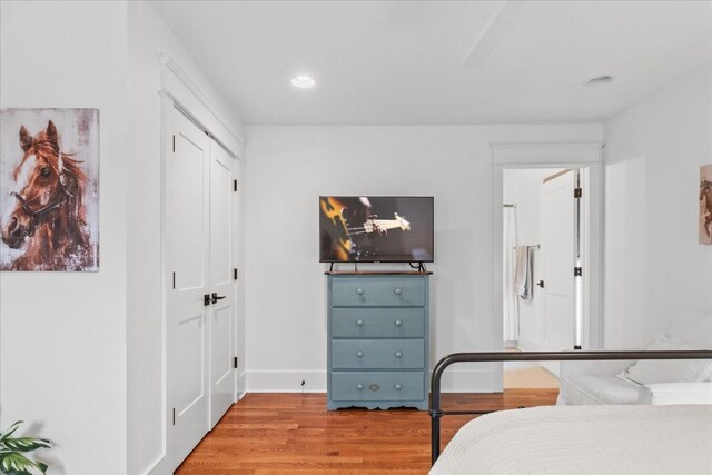 bedroom with recessed lighting, baseboards, and wood finished floors