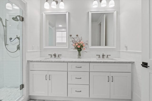 bathroom featuring double vanity, a sink, and a shower stall