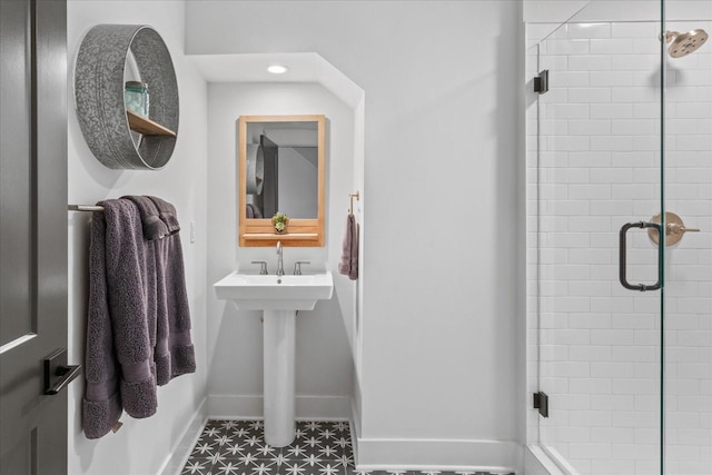 bathroom featuring recessed lighting, a shower stall, and baseboards