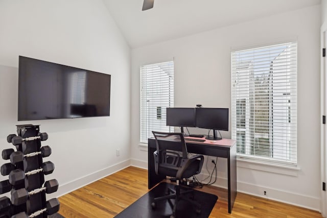 office area with lofted ceiling, plenty of natural light, wood finished floors, and baseboards