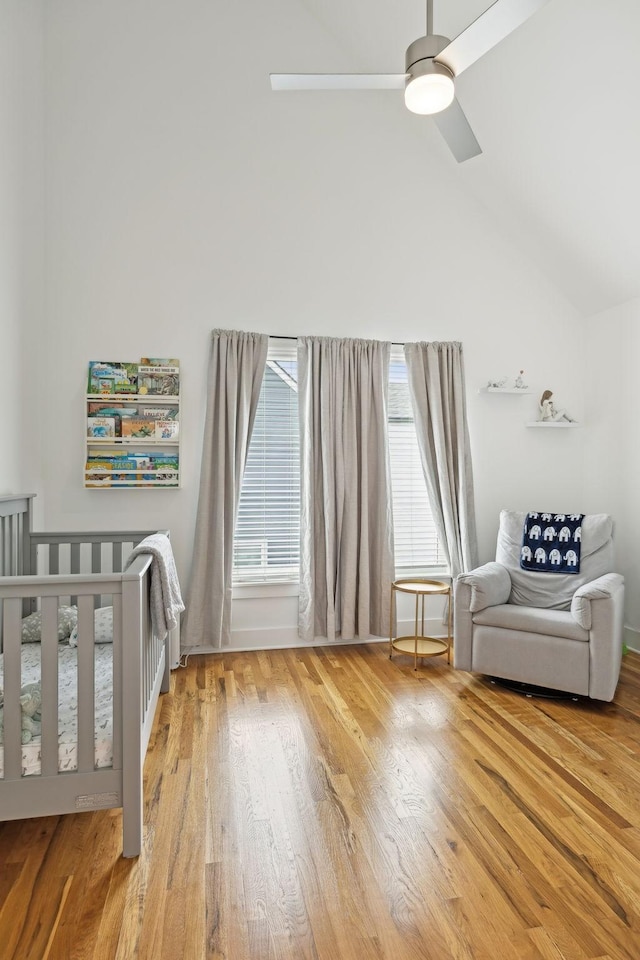 unfurnished bedroom featuring a ceiling fan, high vaulted ceiling, and wood finished floors