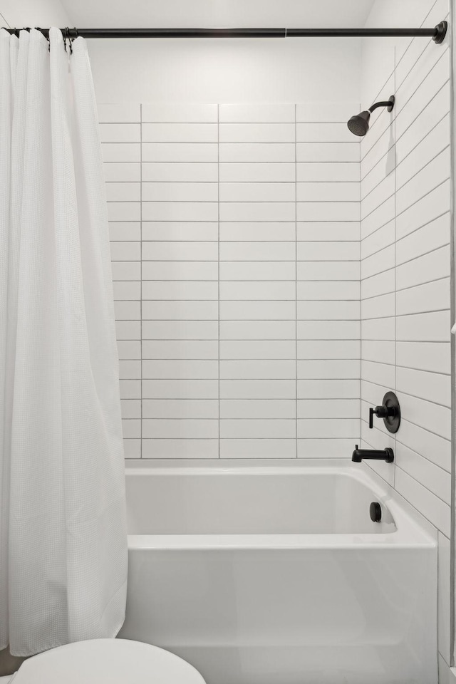 bathroom with toilet and shower / bathtub combination with curtain