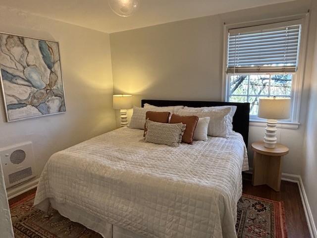 bedroom with baseboards and wood finished floors