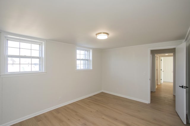 spare room with light wood-type flooring and baseboards