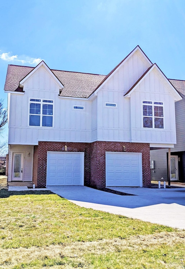 view of front of property with a garage, concrete driveway, board and batten siding, and a front yard