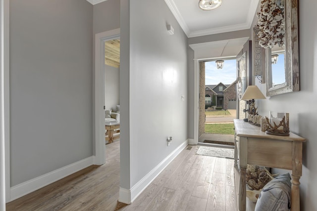 foyer with baseboards, light wood-style flooring, and crown molding