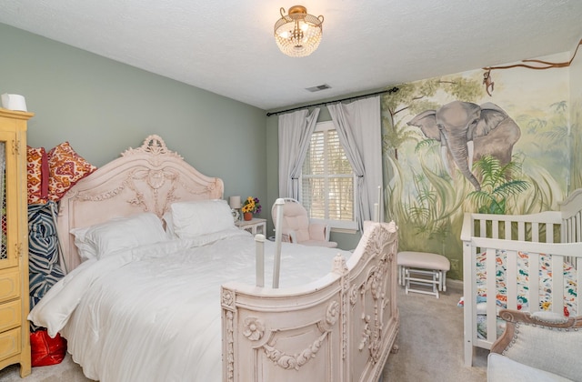 bedroom with light carpet, visible vents, and a textured ceiling