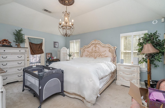 bedroom featuring lofted ceiling, a notable chandelier, visible vents, and light colored carpet