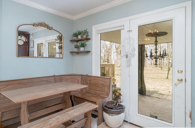 dining space with ornamental molding, breakfast area, and a notable chandelier