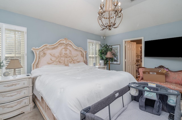 bedroom with a chandelier and light carpet