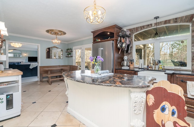 kitchen featuring a chandelier, a sink, high end refrigerator, and light tile patterned floors