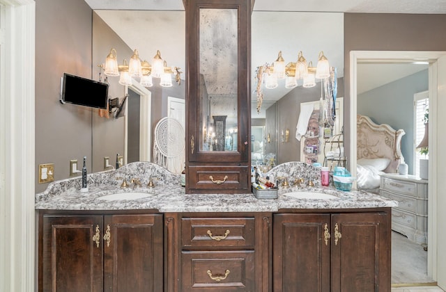 full bathroom with double vanity and a sink