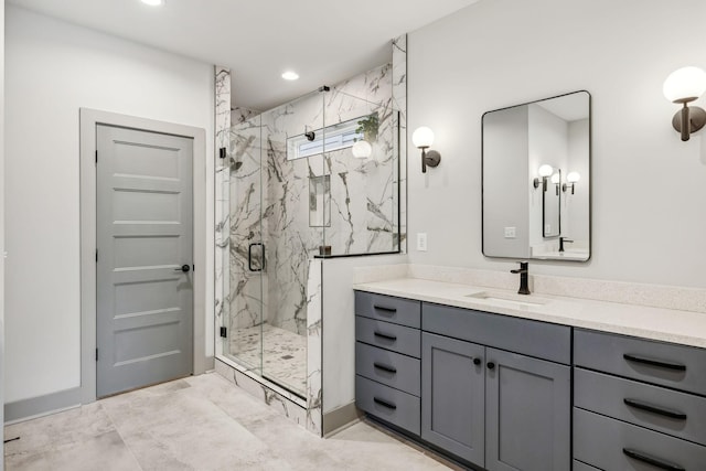 bathroom with a marble finish shower, vanity, and recessed lighting