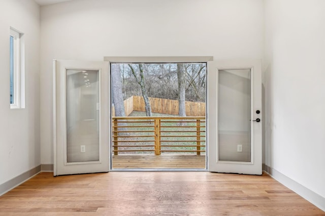 entryway with baseboards and wood finished floors