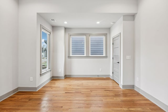 spare room with light wood-style floors, baseboards, and recessed lighting