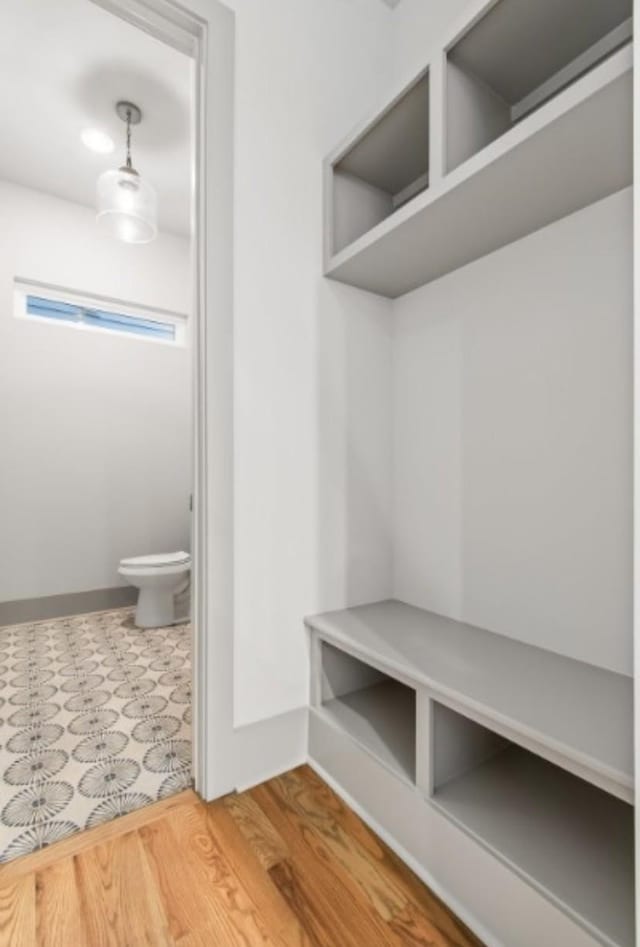 mudroom with wood finished floors and baseboards