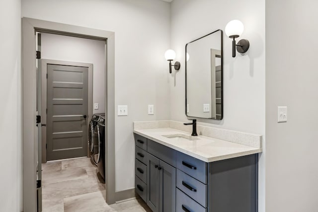 bathroom featuring independent washer and dryer and vanity