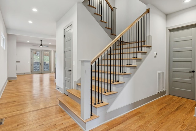 staircase featuring recessed lighting, french doors, visible vents, and wood finished floors