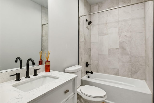 bathroom with bathing tub / shower combination, vanity, and toilet