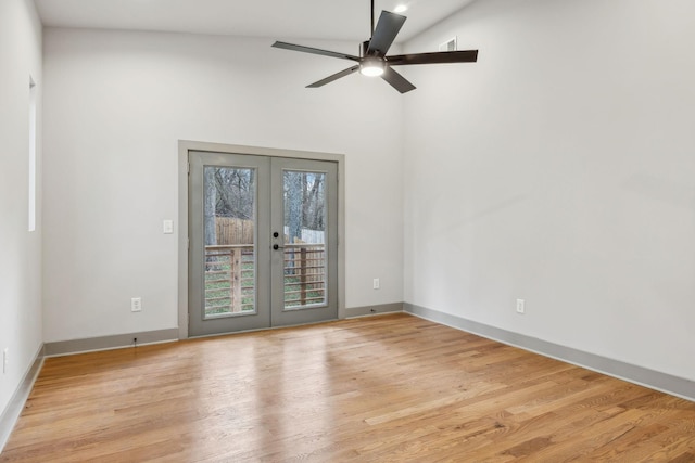 spare room featuring a ceiling fan, french doors, light wood-style flooring, and baseboards