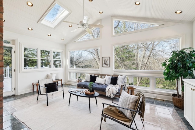 sunroom / solarium with a wealth of natural light, lofted ceiling with skylight, and ceiling fan