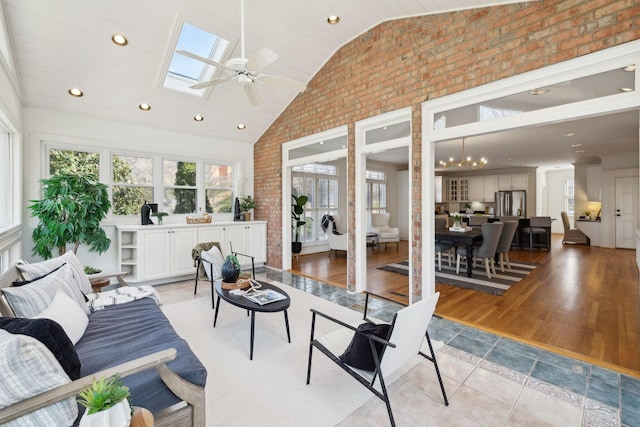 sunroom / solarium featuring vaulted ceiling with skylight