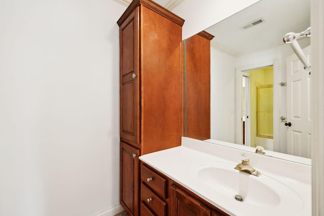 bathroom with a shower, visible vents, vanity, and crown molding