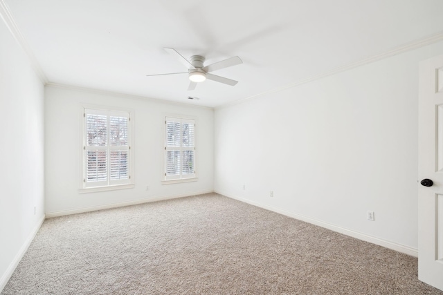 spare room with baseboards, carpet, ceiling fan, and ornamental molding