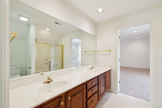 bathroom with a shower stall, ornamental molding, visible vents, and a sink