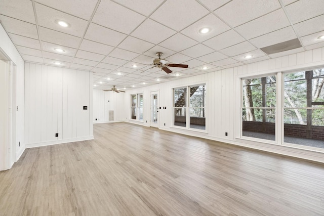 unfurnished living room with light wood-style flooring, plenty of natural light, and ceiling fan