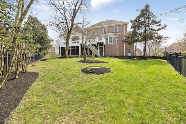 view of yard featuring a deck, stairway, and a fenced backyard
