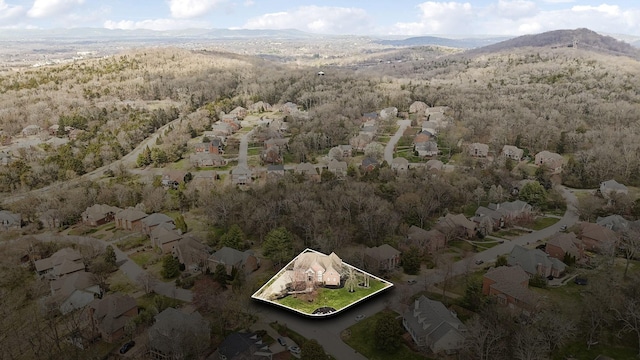 aerial view featuring a forest view and a mountain view