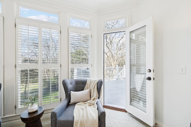 living area with a wealth of natural light and crown molding