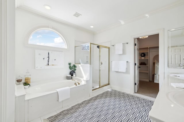 bathroom featuring a garden tub, visible vents, a shower stall, a spacious closet, and crown molding