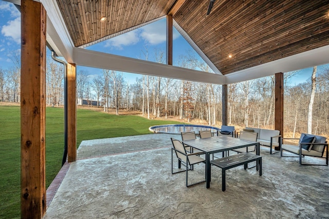 view of patio / terrace featuring outdoor dining area and a pool