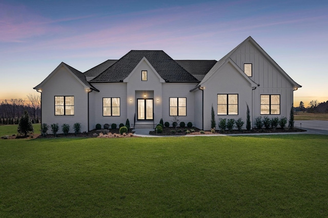 modern farmhouse featuring board and batten siding and a front yard