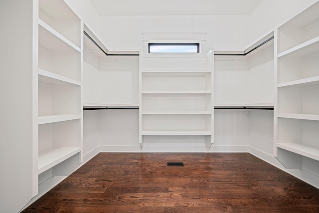 walk in closet featuring visible vents and dark wood-type flooring