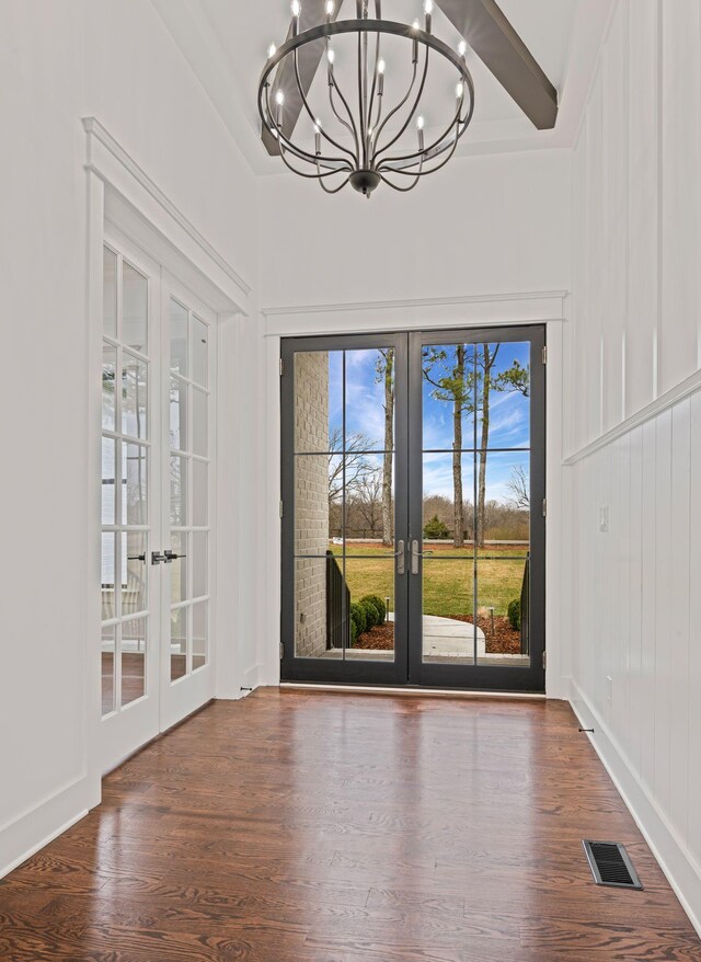 interior space featuring a chandelier, french doors, visible vents, and dark wood finished floors