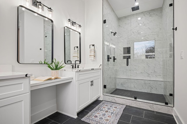 full bathroom featuring a stall shower, tile patterned flooring, baseboards, and vanity