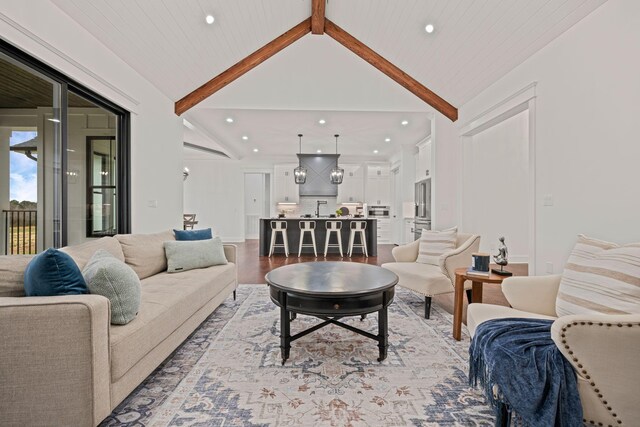 living room with light wood-style flooring, high vaulted ceiling, beamed ceiling, and recessed lighting