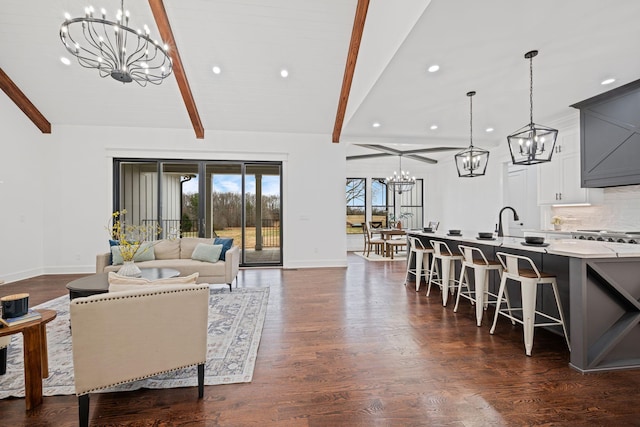 living area featuring dark wood-style flooring, vaulted ceiling with beams, recessed lighting, a chandelier, and baseboards