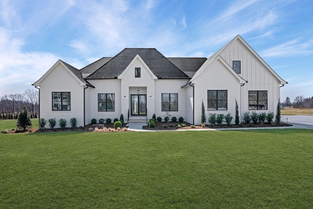 modern farmhouse style home featuring a front lawn and board and batten siding