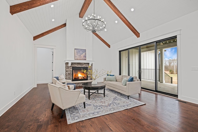 living room featuring beam ceiling, a fireplace, wood finished floors, and visible vents