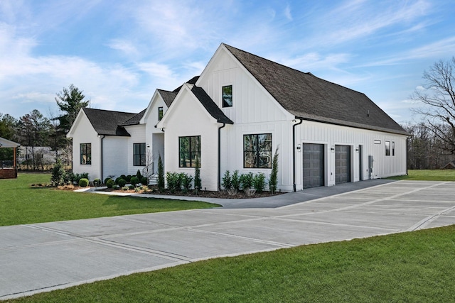 modern inspired farmhouse featuring board and batten siding, a shingled roof, concrete driveway, and a front yard